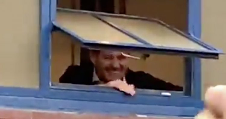 Steven Gerrard celebrates with rule-breaking Rangers fans from Ibrox window