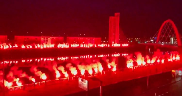 Rangers fans let off hundreds of red flares over the River Clyde